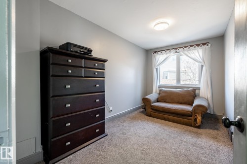 Room featuring light gray walls, carpet flooring, and a window with white curtains - 7 Doolan Place, St. Albert, AB - Indoor Photo Showing Bedroom
