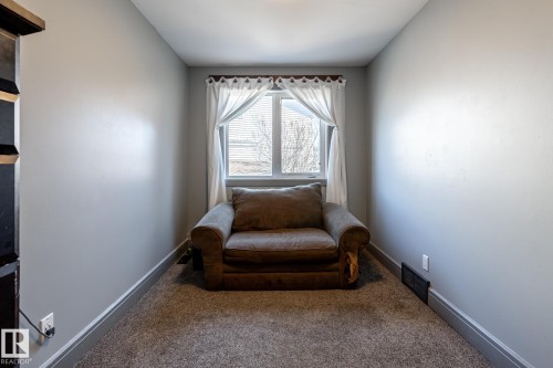 Cozy room featuring neutral gray wall paint, a window with white blinds and curtains, and gray carpet flooring - 7 Doolan Place, St. Albert, AB - Indoor