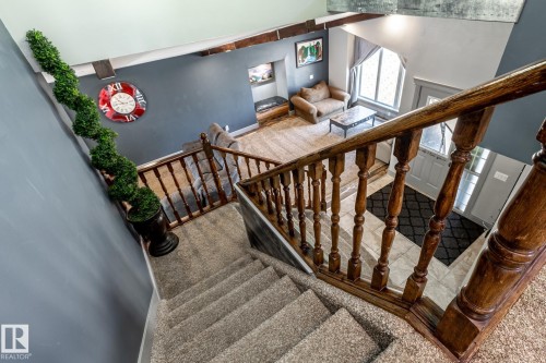 Carpeted staircase with dark wood-finish railing and balusters - 7 Doolan Place, St. Albert, AB - Indoor Photo Showing Other Room