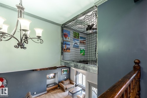 Two-story living area with an open loft space featuring a safety net - 7 Doolan Place, St. Albert, AB - Indoor Photo Showing Other Room