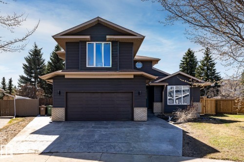 Contemporary two-story exterior featuring dark horizontal siding, a two-car attached garage, and a concrete driveway - 7 Doolan Place, St. Albert, AB - Outdoor