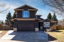 Contemporary two-story exterior featuring dark horizontal siding, a two-car attached garage, and a concrete driveway - 7 Doolan Place, St. Albert, AB  - Outdoor 
