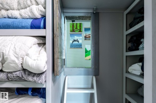 Built-in bunk beds featuring a ladder and an open access panel - 7 Doolan Place, St. Albert, AB - Indoor