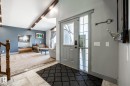 Entryway with a gray front door and sidelight, tile flooring, and a contrasting carpeted living space - 7 Doolan Place, St. Albert, AB  - Indoor Photo Showing Other Room 