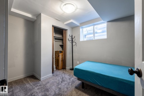 Bedroom featuring a window, neutral wall paint, ceiling-mounted light fixture, and carpet flooring - 7 Doolan Place, St. Albert, AB - Indoor
