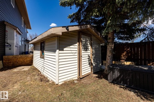 Detached utility shed with horizontal siding, a single window, and a wood-finish door - 7 Doolan Place, St. Albert, AB - Outdoor