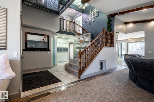 Grand staircase featuring wood balusters and carpeted treads - 7 Doolan Place, St. Albert, AB - Indoor Photo Showing Other Room