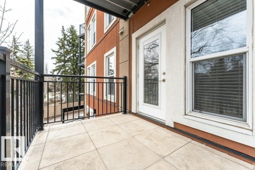 Private outdoor balcony featuring square tile flooring and black metal railings - 204 10126 144 Street, Edmonton, AB - Outdoor With Balcony With Exterior