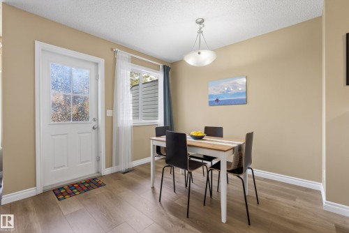 Dining area featuring wood-finish flooring, a white trim package, and light tan wall paint - 17 171 Brintnell Boulevard, Edmonton, AB - Indoor Photo Showing Dining Room