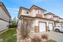 Multi-level townhouse exterior featuring light-toned siding and contrasting brown trim - 17 171 Brintnell Boulevard, Edmonton, AB  - Outdoor 