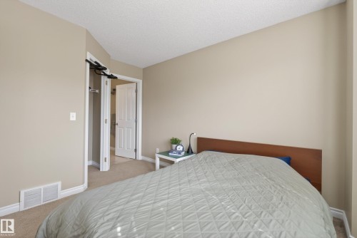 Neutral tone walls with white baseboards and trim - 17 171 Brintnell Boulevard, Edmonton, AB - Indoor Photo Showing Bedroom