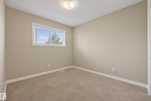 Neutral-toned room featuring a single window with horizontal blinds, providing natural illumination - 17 171 Brintnell Boulevard, Edmonton, AB - Indoor Photo Showing Other Room