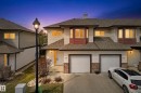Townhome exterior featuring light-colored siding, dark shingles, and stone accents - 17 171 Brintnell Boulevard, Edmonton, AB  - Outdoor 