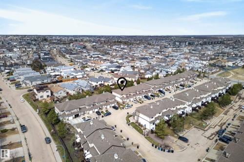 Aerial overview of a residential neighborhood featuring rows of townhomes with attached garages and individual driveways - 17 171 Brintnell Boulevard, Edmonton, AB -  With View