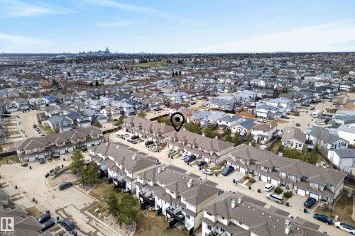 Aerial perspective showcasing a residential community with multiple townhome rows and single-detached residences - 17 171 Brintnell Boulevard, Edmonton, AB - Outdoor With View