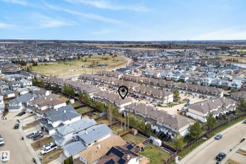 Aerial perspective showcasing a residential community with rows of townhomes and single-family residences - 17 171 Brintnell Boulevard, Edmonton, AB - Outdoor With View