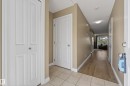 Entryway featuring light-toned tile flooring transitioning to wood-finish flooring - 17 171 Brintnell Boulevard, Edmonton, AB  - Indoor Photo Showing Other Room 