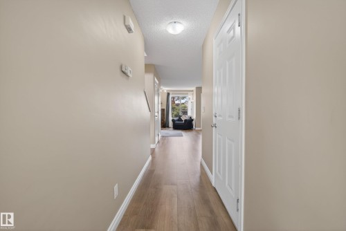Entryway featuring wood-finish flooring and neutral wall tones - 17 171 Brintnell Boulevard, Edmonton, AB - Indoor Photo Showing Other Room