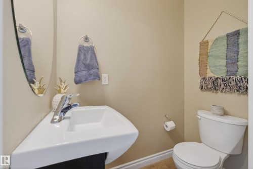 White corner-mounted sink with a chrome faucet - 17 171 Brintnell Boulevard, Edmonton, AB - Indoor Photo Showing Bathroom