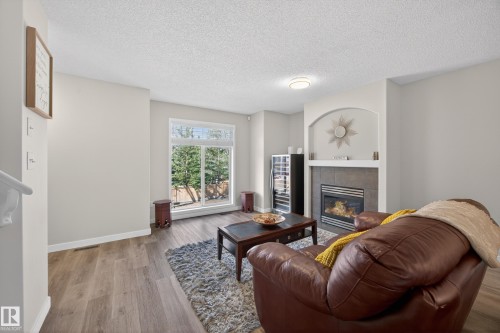 26 4731 Terwillegar Common, Edmonton, AB - Indoor Photo Showing Living Room With Fireplace