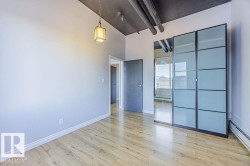 Light wood-finish flooring complements the neutral wall color in this space - 