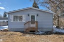 Light blue siding exterior featuring white trim and a gabled roofline - 4712 49 Street, Calmar, AB  - Outdoor 