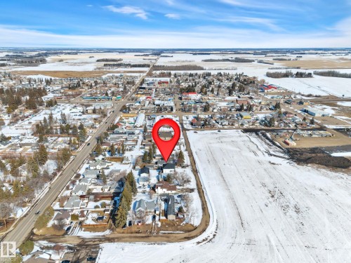 Aerial perspective of a small community with residential properties and commercial establishments - 4712 49 Street, Calmar, AB - Outdoor With View
