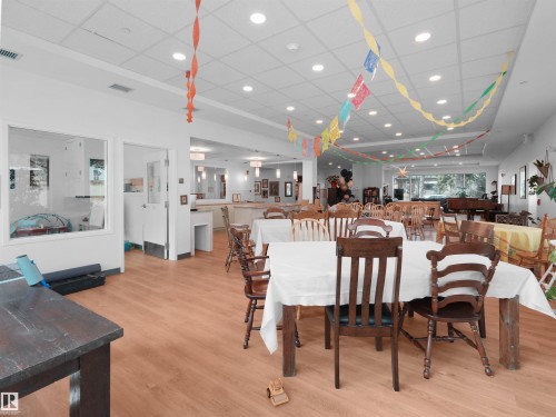 Spacious common area featuring wood-finish flooring and recessed lighting - 403 10115 88 Avenue, Edmonton, AB - Indoor Photo Showing Dining Room