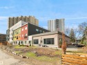 Modern multi-story building featuring colorful facade panels and multiple balconies - 403 10115 88 Avenue, Edmonton, AB  - Outdoor 