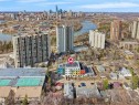 Modern townhome building featuring a vibrant multi-colored facade and rooftop solar panels - 403 10115 88 Avenue, Edmonton, AB  - Outdoor With View 