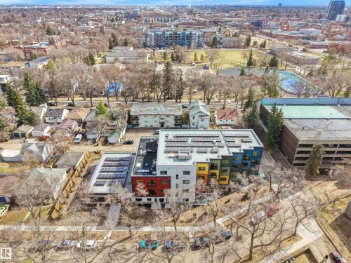 Modern residential development featuring colorful facades and extensive rooftop solar panels - 403 10115 88 Avenue, Edmonton, AB - Outdoor With View