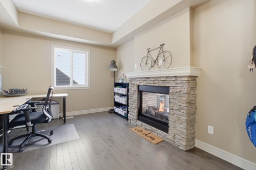 2133 Blue Jay Point(E), Edmonton, AB - Indoor Photo Showing Other Room With Fireplace