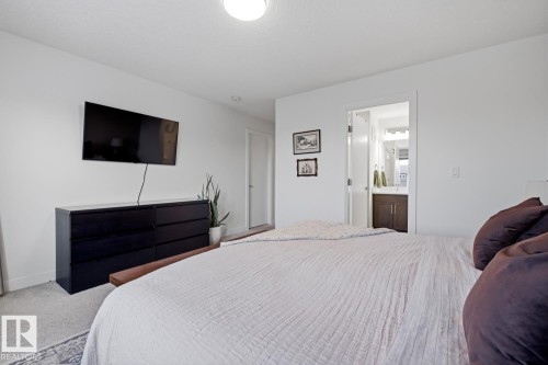 The bedroom features light-colored walls and carpeted flooring - 405 Genesis Court, Stony Plain, AB - Indoor Photo Showing Bedroom