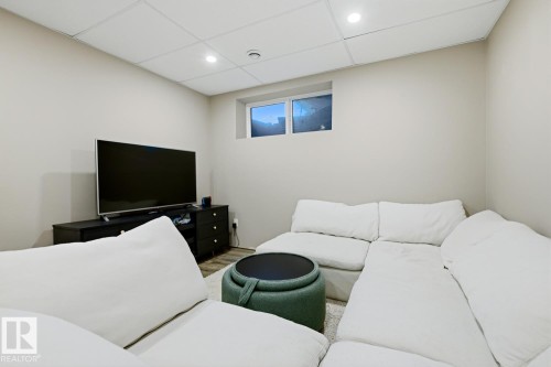 This room features recessed lighting, a drop ceiling, and a window providing natural light - 405 Genesis Court, Stony Plain, AB - Indoor
