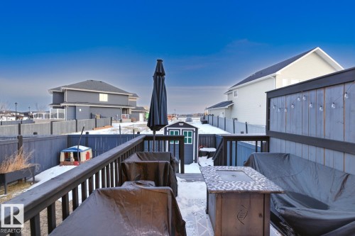 The property features a spacious deck with a privacy screen and a dedicated storage shed - 405 Genesis Court, Stony Plain, AB - Outdoor With Deck Patio Veranda With Exterior