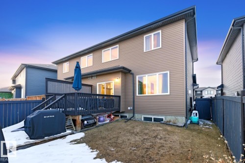 The property features a private deck and a yard with a partial lawn and fenced perimeter - 405 Genesis Court, Stony Plain, AB - Outdoor With Deck Patio Veranda With Exterior