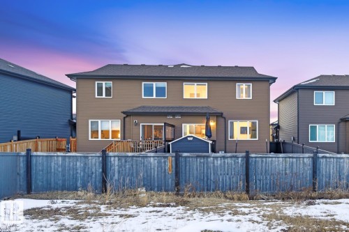 The property features a brown siding exterior, a rear deck, and a shed - 405 Genesis Court, Stony Plain, AB - Outdoor With Deck Patio Veranda With Exterior