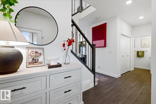 Entryway with dark wood flooring, white walls, and a staircase featuring dark wood newel posts and railings - 405 Genesis Court, Stony Plain, AB - Indoor Photo Showing Other Room