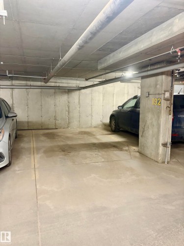 Designated parking space with concrete flooring - 114 3207 James Mowatt Trail, Edmonton, AB - Indoor Photo Showing Garage