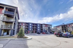Multi-level residential building featuring a stone and siding exterior with private balconies and patios - 