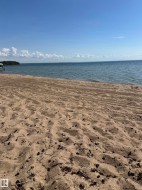 Sandy shoreline bordering a body of water - 