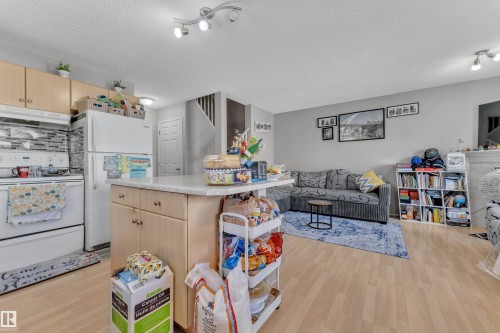 Open-concept living space with wood-finish flooring - 64 4350 23 Street, Edmonton, AB - Indoor Photo Showing Kitchen