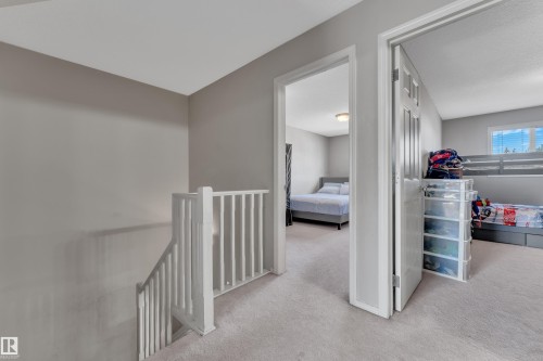Upper-level hallway with light gray walls and plush carpet flooring - 64 4350 23 Street, Edmonton, AB - Indoor