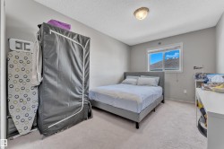 Bright room featuring neutral wall paint, light-colored carpet flooring, a window with white trim, and a ceiling-mounted light fixture - 