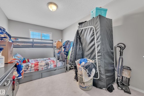 Light gray walls complement the neutral carpeting in this room, featuring a double window with white blinds - 64 4350 23 Street, Edmonton, AB - Indoor