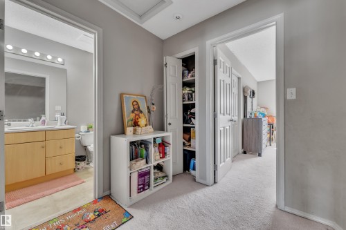 Hallway with light gray walls and plush carpet flooring - 64 4350 23 Street, Edmonton, AB - Indoor