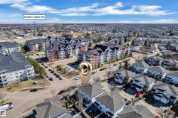 Aerial view showcasing a residential area with townhomes and multi-story apartment buildings - 