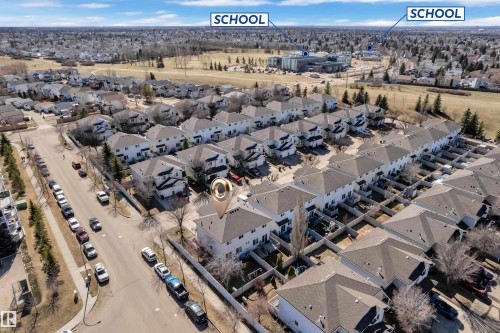 Aerial perspective showcasing a residential neighborhood with detached homes and townhouses - 64 4350 23 Street, Edmonton, AB - Outdoor With View