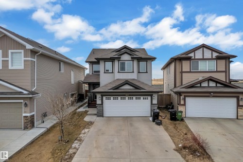 Two-story residence featuring light gray siding with dark trim accents and a dual-car garage - 3363 13 Avenue, Edmonton, AB - Outdoor With Facade