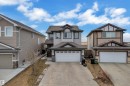 Two-story residence featuring light gray siding with dark trim accents and a dual-car garage - 3363 13 Avenue, Edmonton, AB  - Outdoor With Facade 